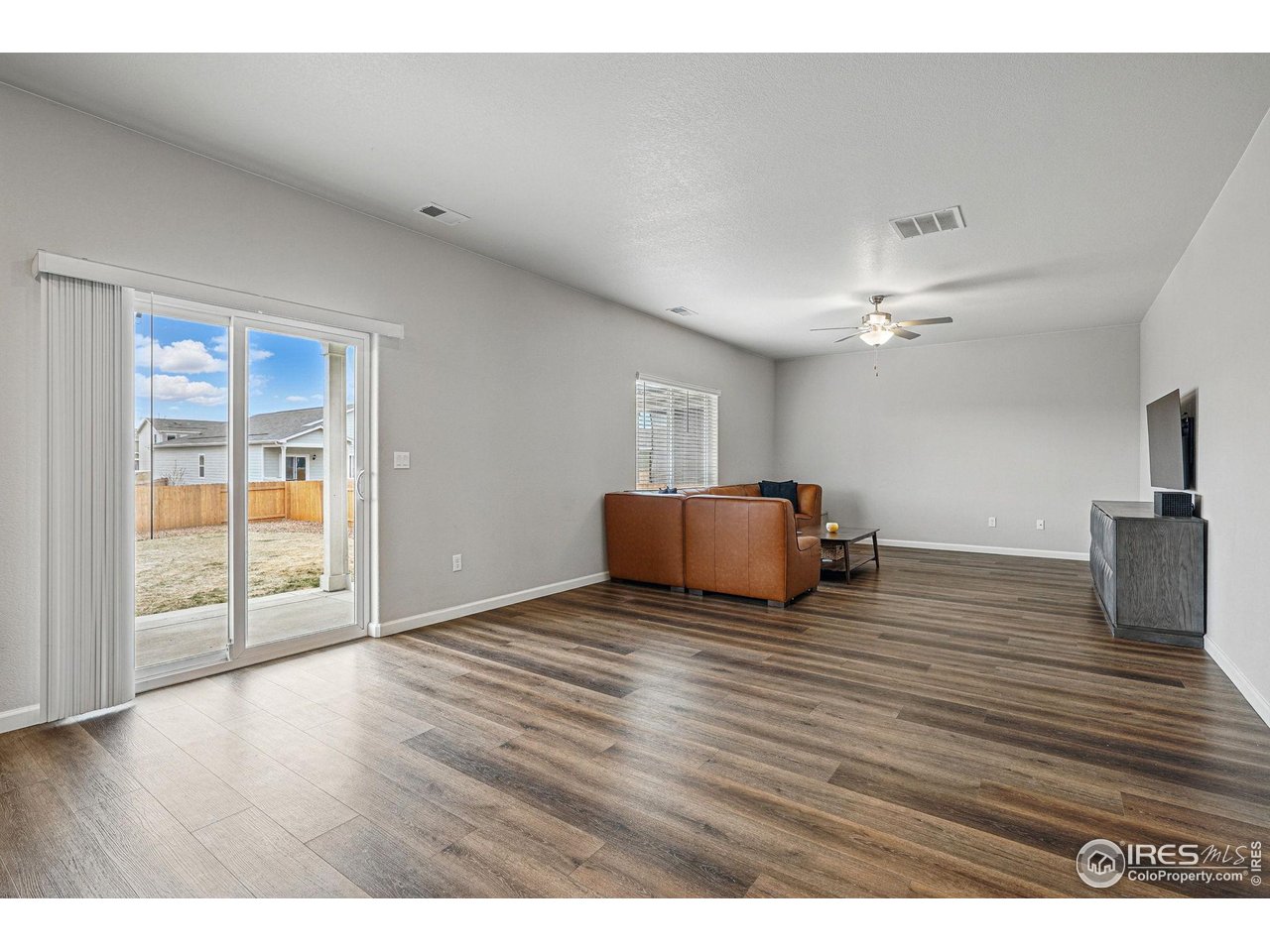 2310 Angus Street Mead, CO 80542 - Photo 8 of 39 a view of an empty room with wooden floor and a window