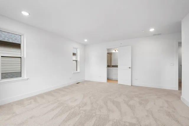a view of an empty room with a kitchen