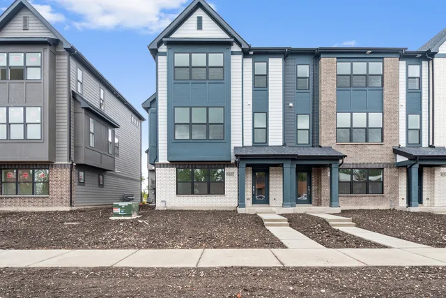 a view of residential houses with wooden walls and stairs