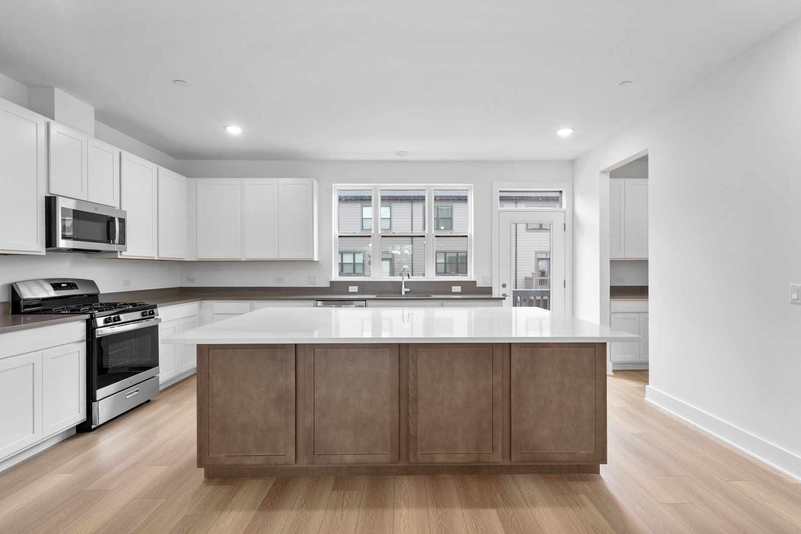 8375 Mulberry Avenue Morton Grove, IL 60053 - Photo 8 of 24 a kitchen with stainless steel appliances granite countertop a stove a sink and a microwave