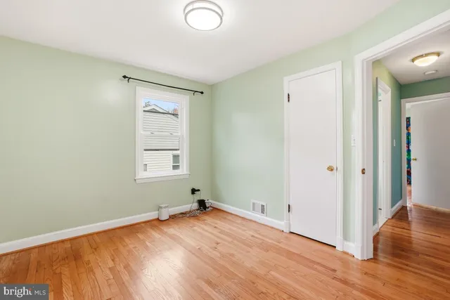a view of a room with wooden floor and window