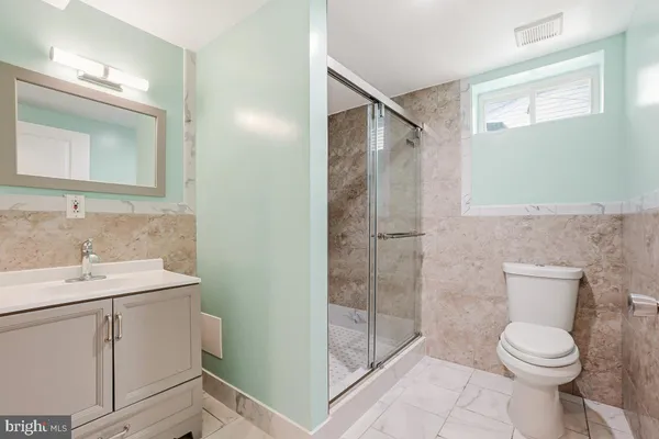 a bathroom with a toilet sink and shower