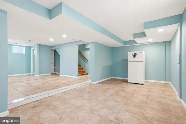 a view of an empty room with closet and entryway