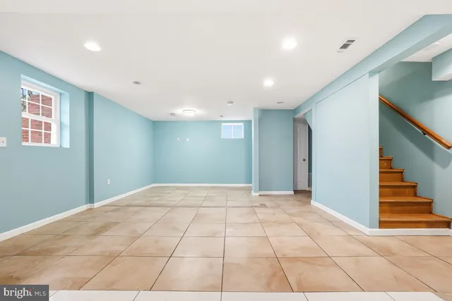 a view of an empty room with stairs and ventilation