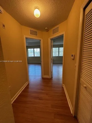 a view of hallway with wooden floor