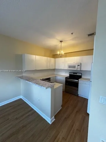 a kitchen with a stove and a microwave