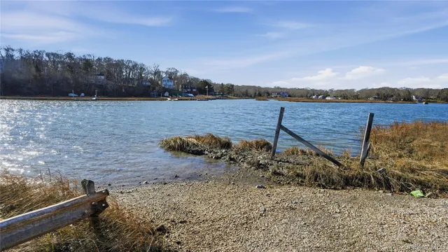 a view of a lake with sunset in background