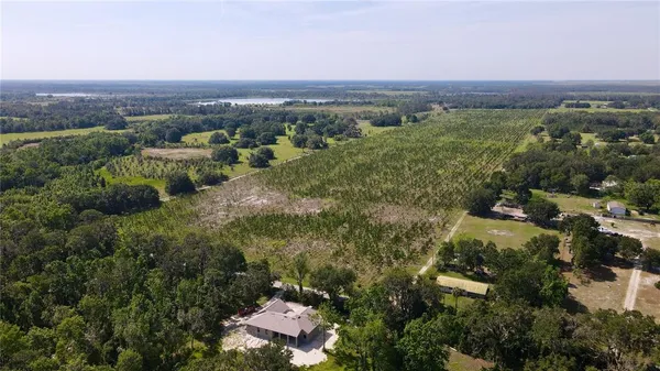 an aerial view of residential house with green space