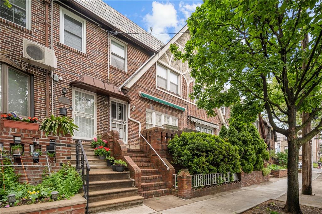 a view of a house with brick walls and plants