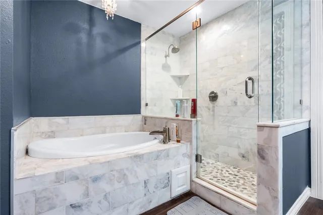 a bathroom with a bathtub and a shower