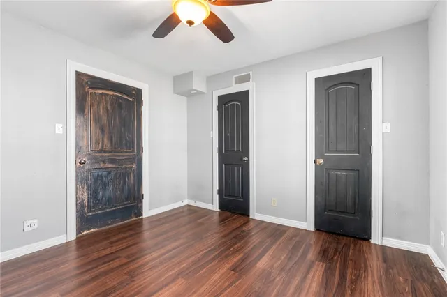 an empty room with wooden floor and closet