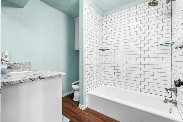 a bathroom with a granite countertop bathtub and sink