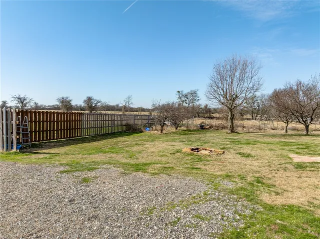 a view of a field with wooden fence