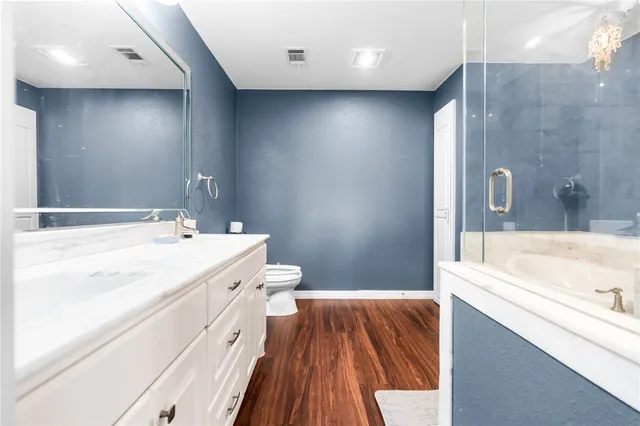 a spacious bathroom with a tub sink and mirror
