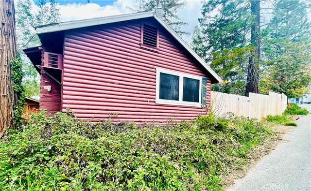 a view of a house with a small yard and plants