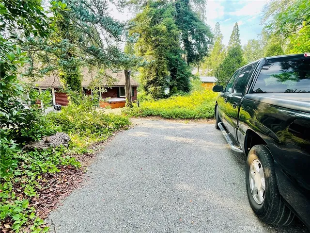 a view of a house with a yard and sitting area