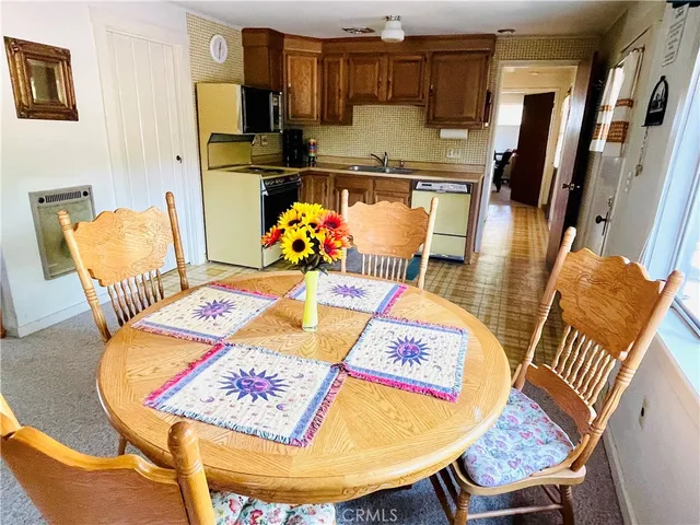 a living room with dining room and wooden floor