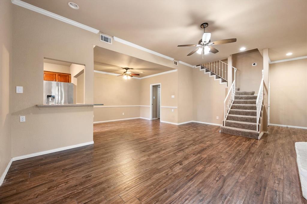 2312 Perkins Road Arlington, TX 76016 - Photo 11 of 37 a view of a livingroom with wooden floor and stairs