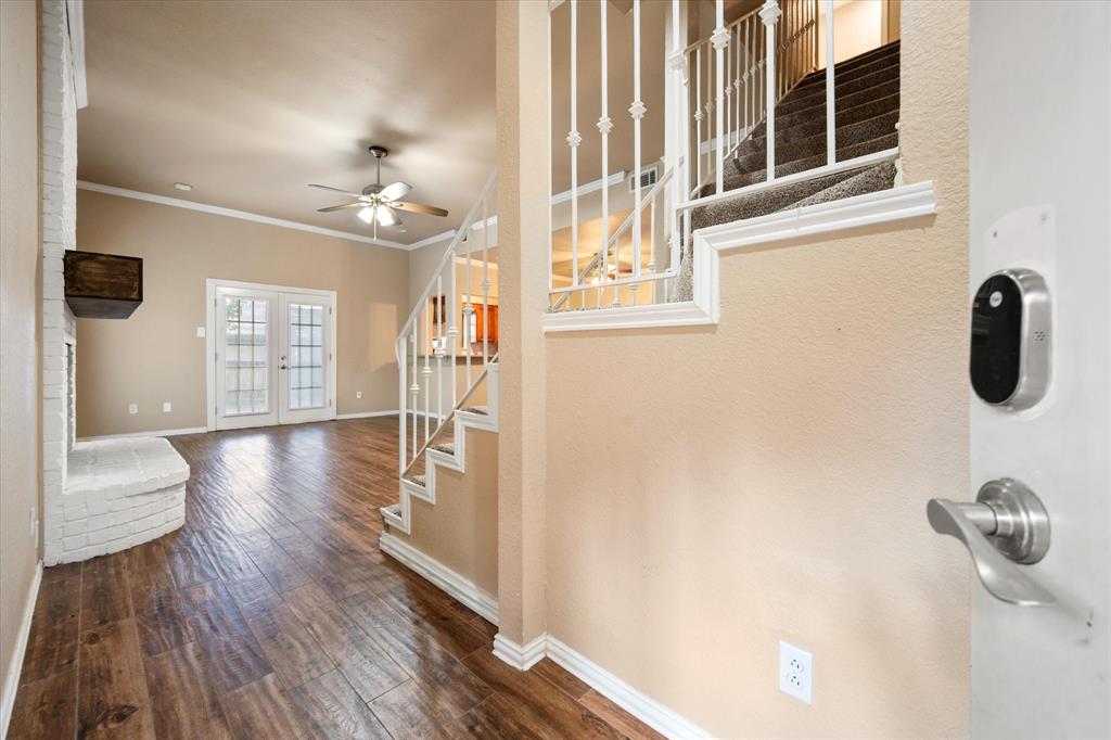 2312 Perkins Road Arlington, TX 76016 - Photo 4 of 37 a view of a hallway with wooden floor and windows