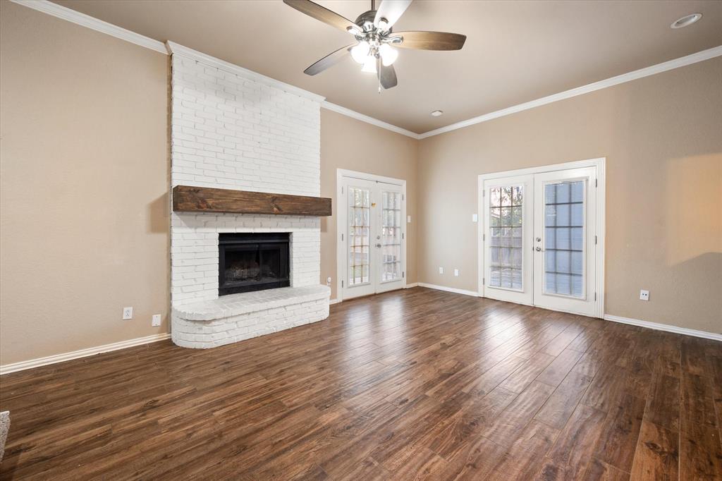 2312 Perkins Road Arlington, TX 76016 - Photo 9 of 37 a view of an empty room with wooden floor and a window