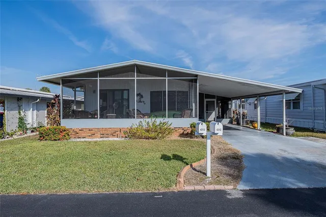a view of a house with backyard porch and sitting area
