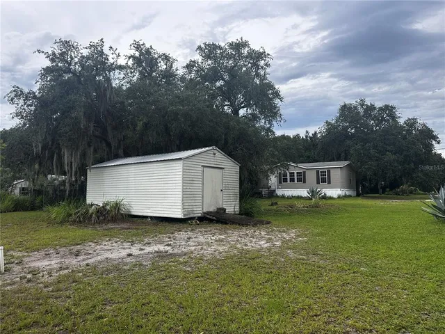 a view of a barn in the middle of a yard