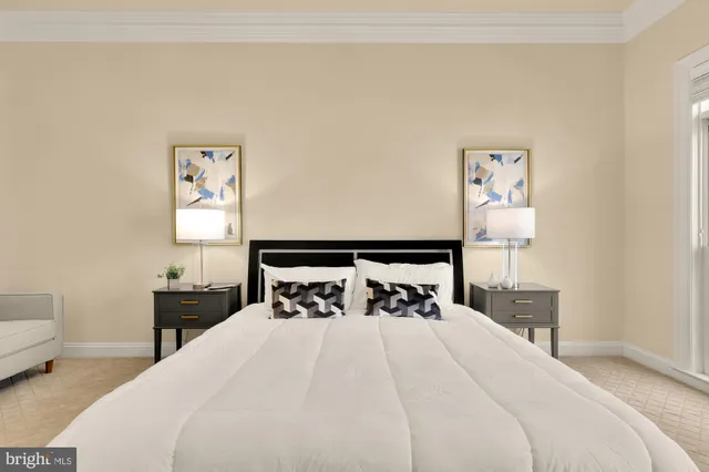 a bedroom with a bed and a painting on the wall