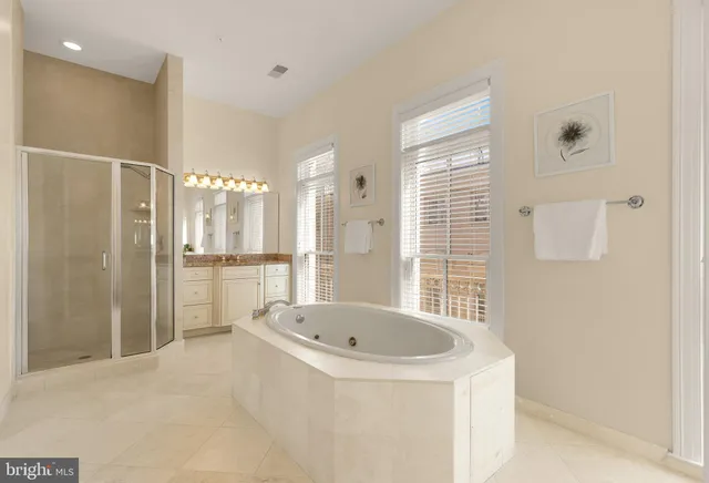 a bathroom with a bathtub and a shower