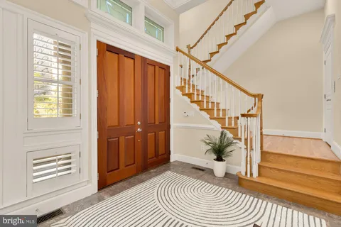 a view of entryway with wooden floor and stairs