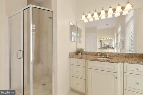 a bathroom with a granite countertop sink mirror and