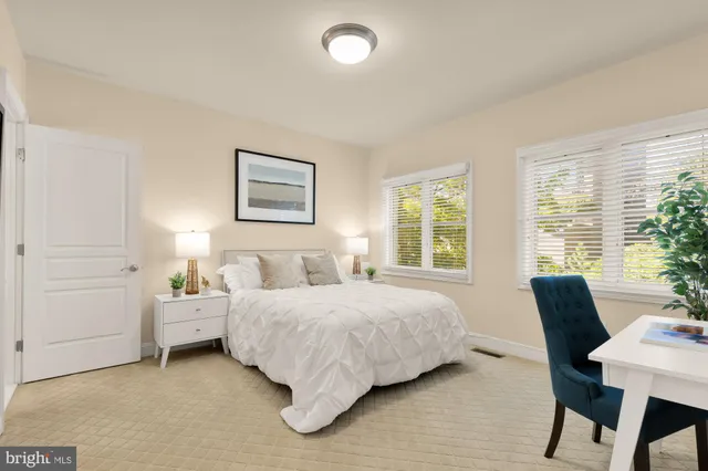 a bedroom with a bed and a table