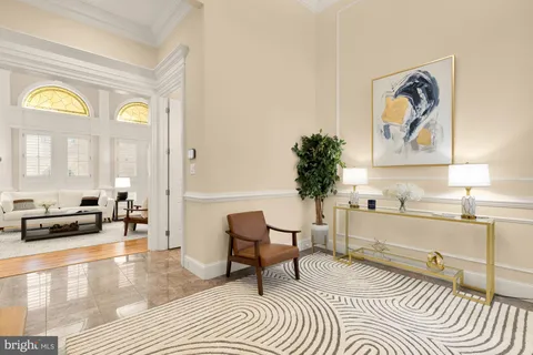 a living room with furniture and a painting on the wall