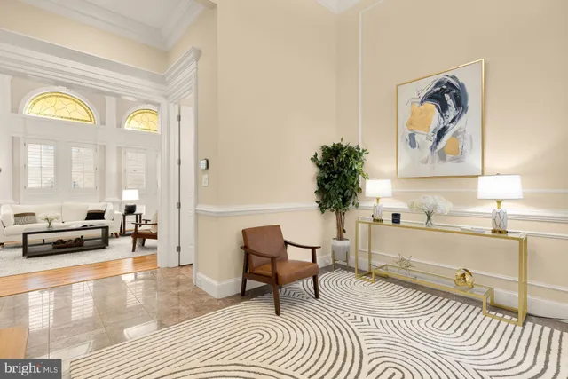 a living room with furniture and a painting on the wall