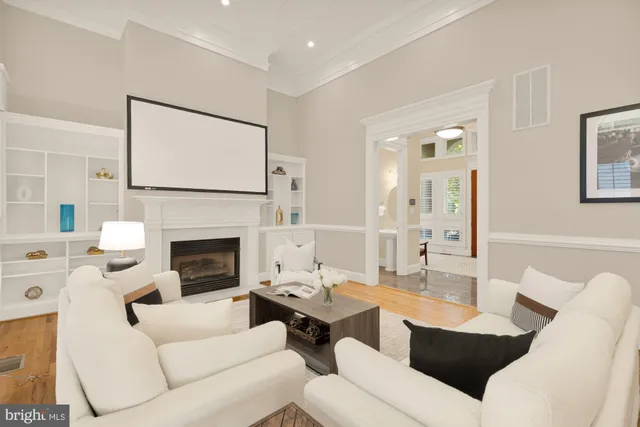 a living room with furniture a fireplace and a flat screen tv