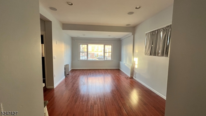 554 Second Avenue, Unit 1 Lyndhurst, NJ 07071 - Photo 2 of 11 an empty room with wooden floor and windows