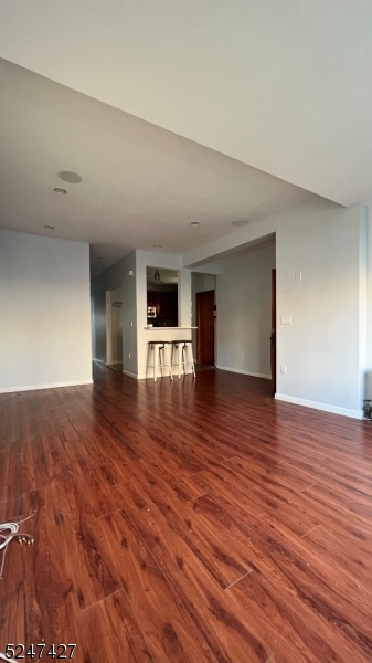 554 Second Avenue, Unit 1 Lyndhurst, NJ 07071 - Photo 6 of 11 a view of an empty room with wooden floor and a window