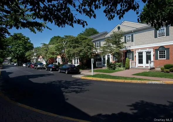 a view of a street with houses on both side
