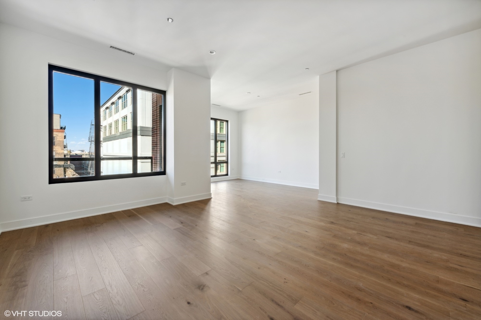 323 South Racine Avenue, Unit 6B Chicago, IL 60607 - Photo 26 of 36 an empty room with wooden floor and windows