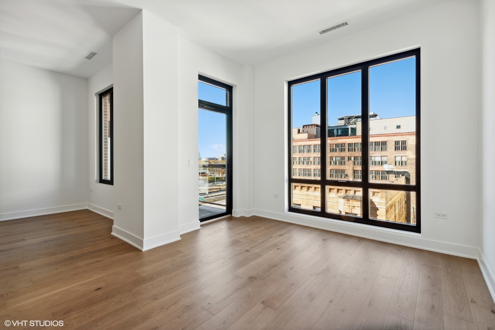 323 South Racine Avenue, Unit 6B Chicago, IL 60607 - Photo 28 of 36 an empty room with wooden floor and windows