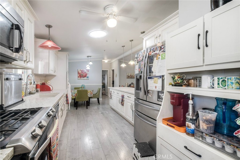 3909 Reche Road, Unit 125 Fallbrook, CA 92028 - Photo 21 of 58 a kitchen with granite countertop lots of counter top space and stainless steel appliances