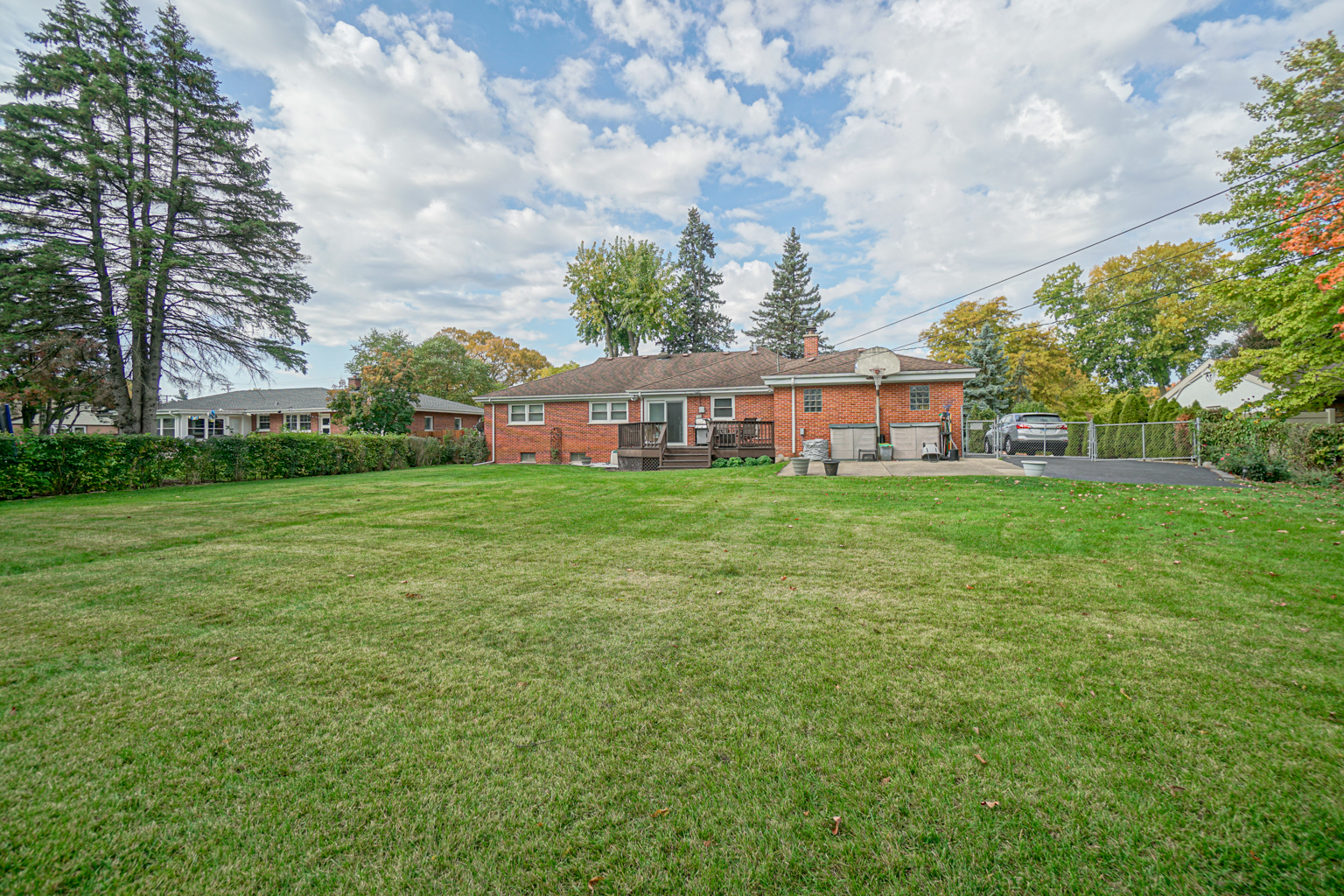 205 South Elmhurst Road Prospect Heights, IL 60070 - Photo 23 of 24 a view of a house with a big yard and large trees