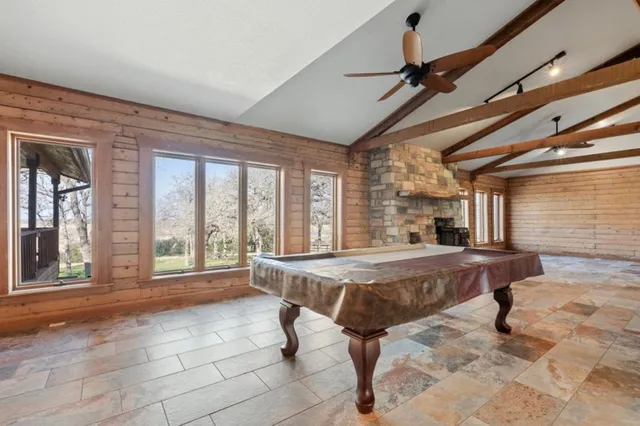 a living room with a large window and furniture