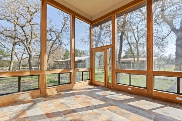 a view of a room with a large window and front door