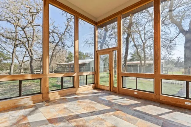 a view of a room with a large window and front door