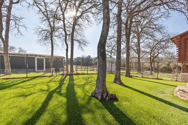 a swimming pool with trees in front of it