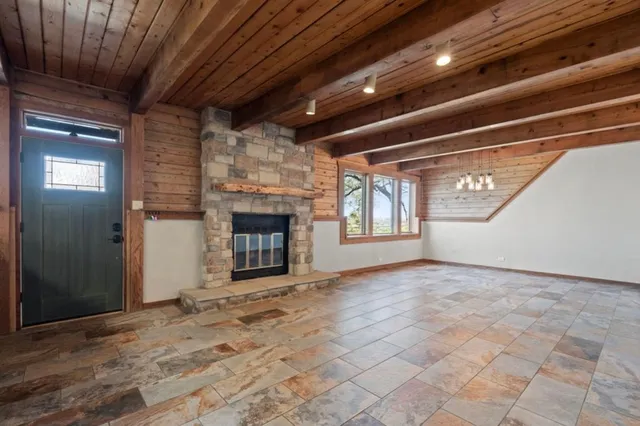 a view of empty room with a fireplace
