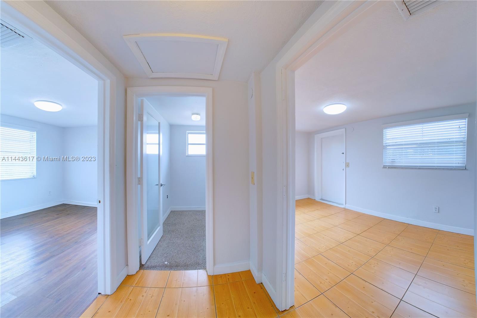 4640 Northwest 7th Street, Unit TOP Miami, FL 33126 - Photo 13 of 23 a view of a hallway with wooden floor