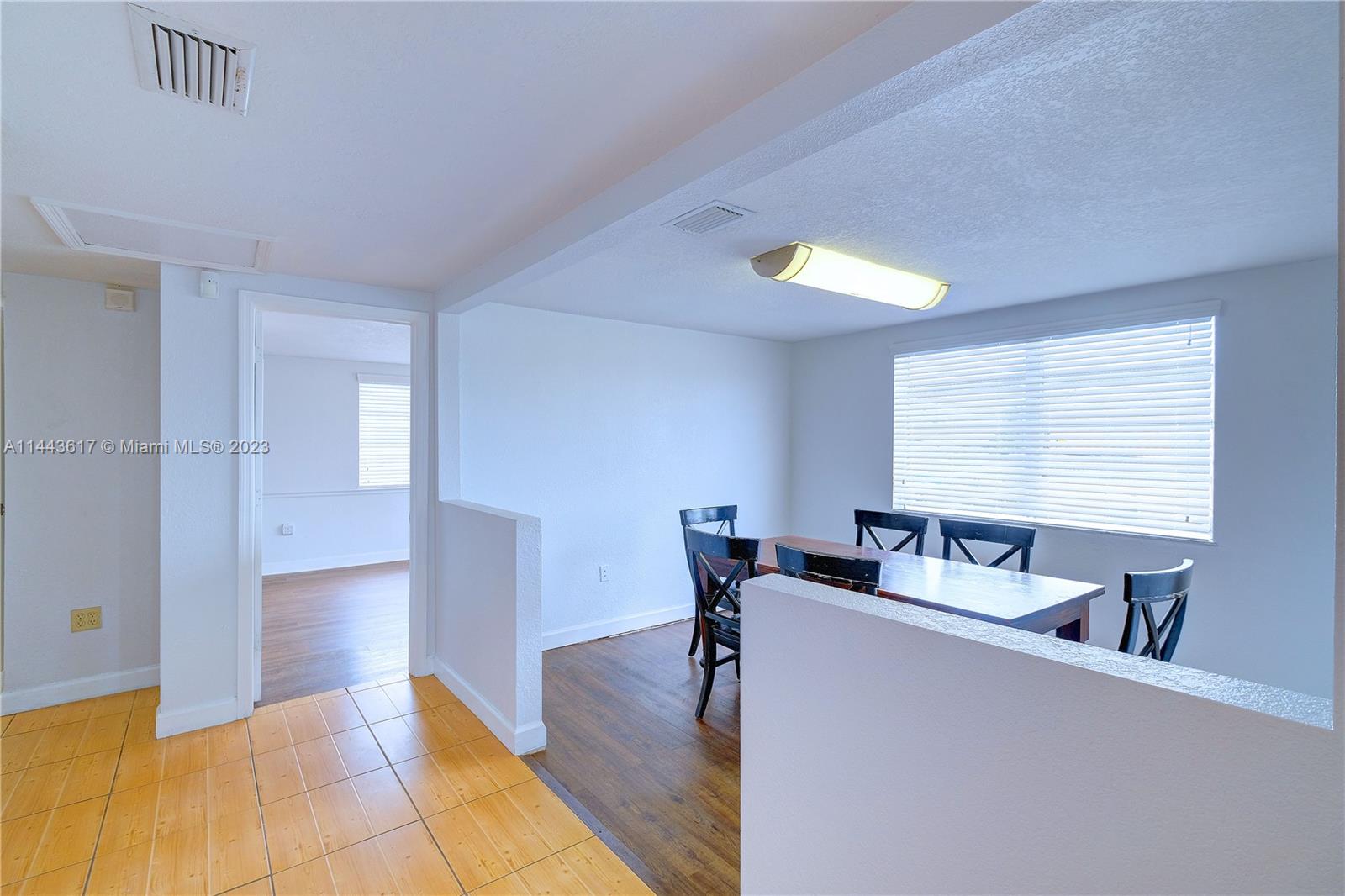 4640 Northwest 7th Street, Unit TOP Miami, FL 33126 - Photo 14 of 23 a living room with furniture and a window