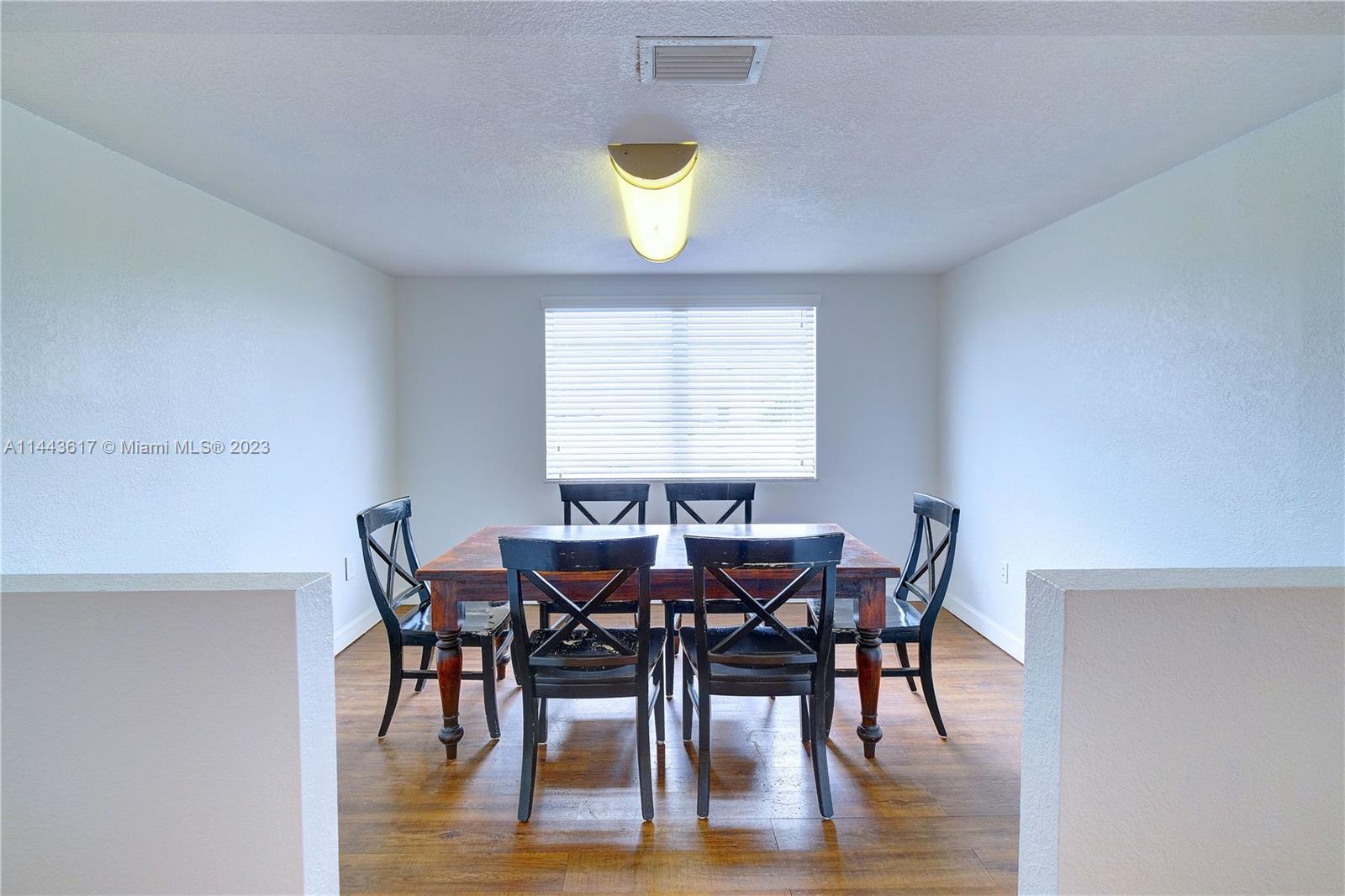 4640 Northwest 7th Street, Unit TOP Miami, FL 33126 - Photo 16 of 23 a view of a dining room with furniture and wooden floor