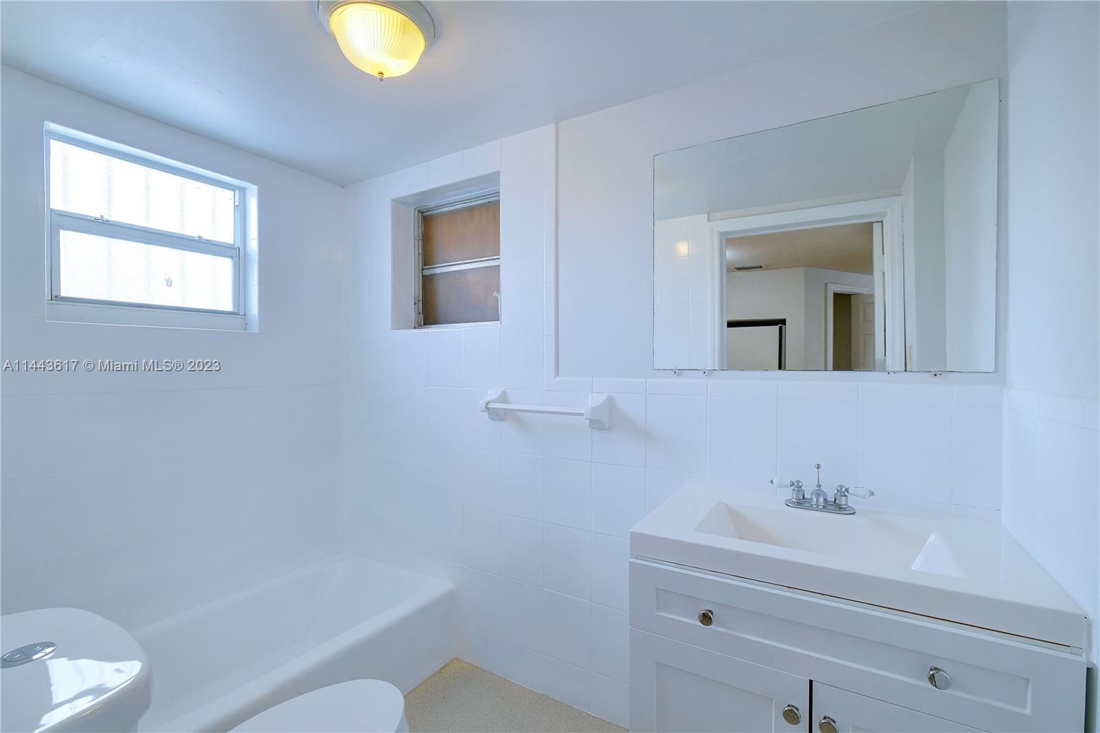 4640 Northwest 7th Street, Unit TOP Miami, FL 33126 - Photo 21 of 23 a bathroom with a sink and a mirror